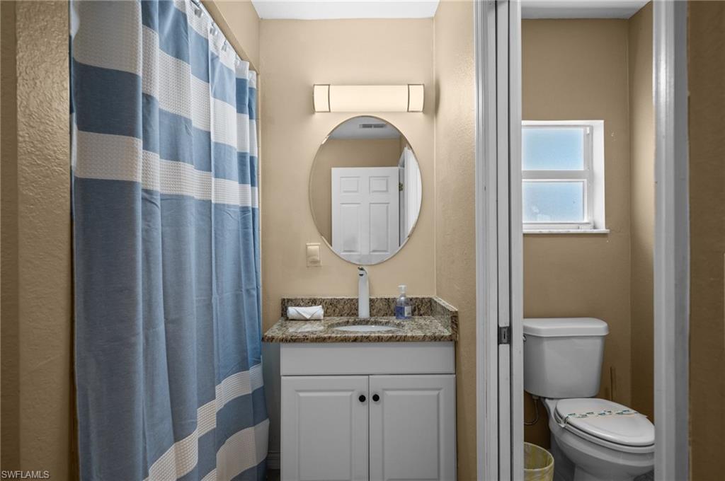 Full bathroom with vanity and a shower with curtain