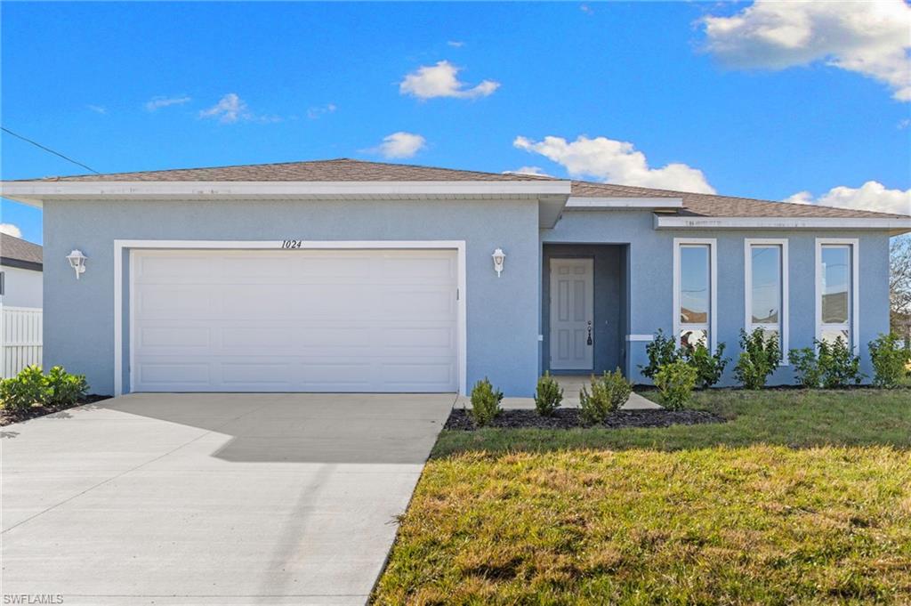 Single story home featuring stucco siding, a front yard, concrete driveway, a garage, and roof with shingles