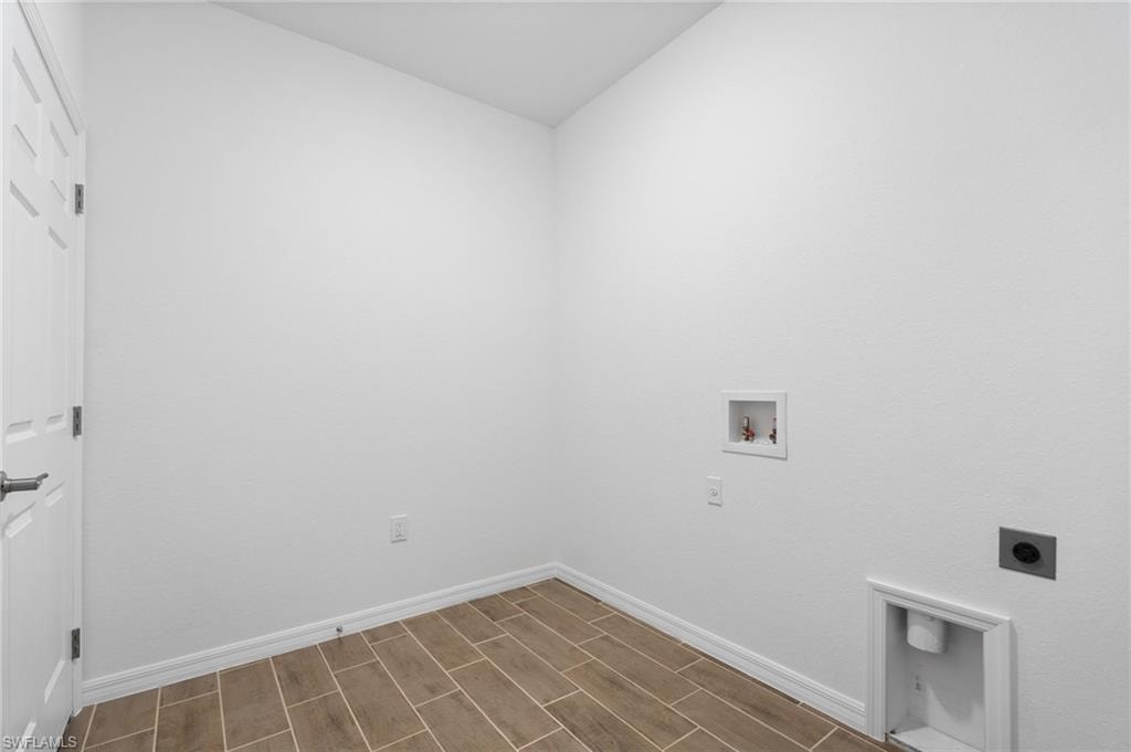 Laundry room with wood tiled floors, hookup for a washing machine, and electric dryer hookup