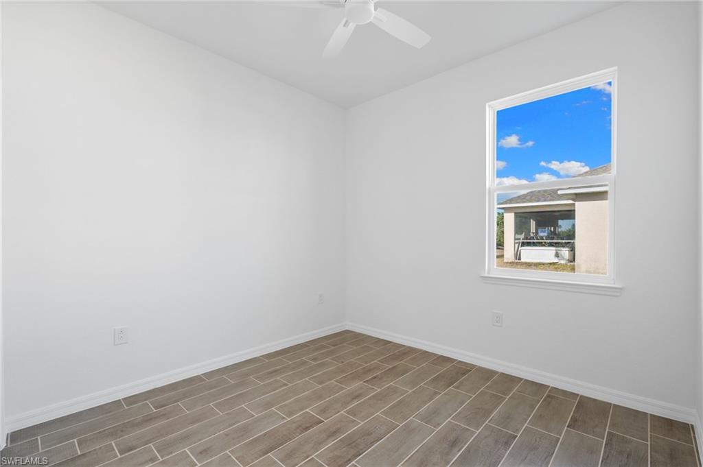 Unfurnished room featuring wood finish floors and ceiling fan