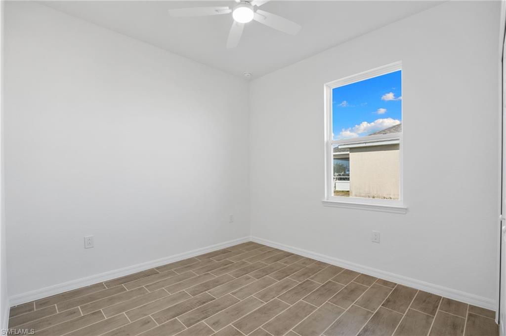 Spare room with wood finish floors and a ceiling fan
