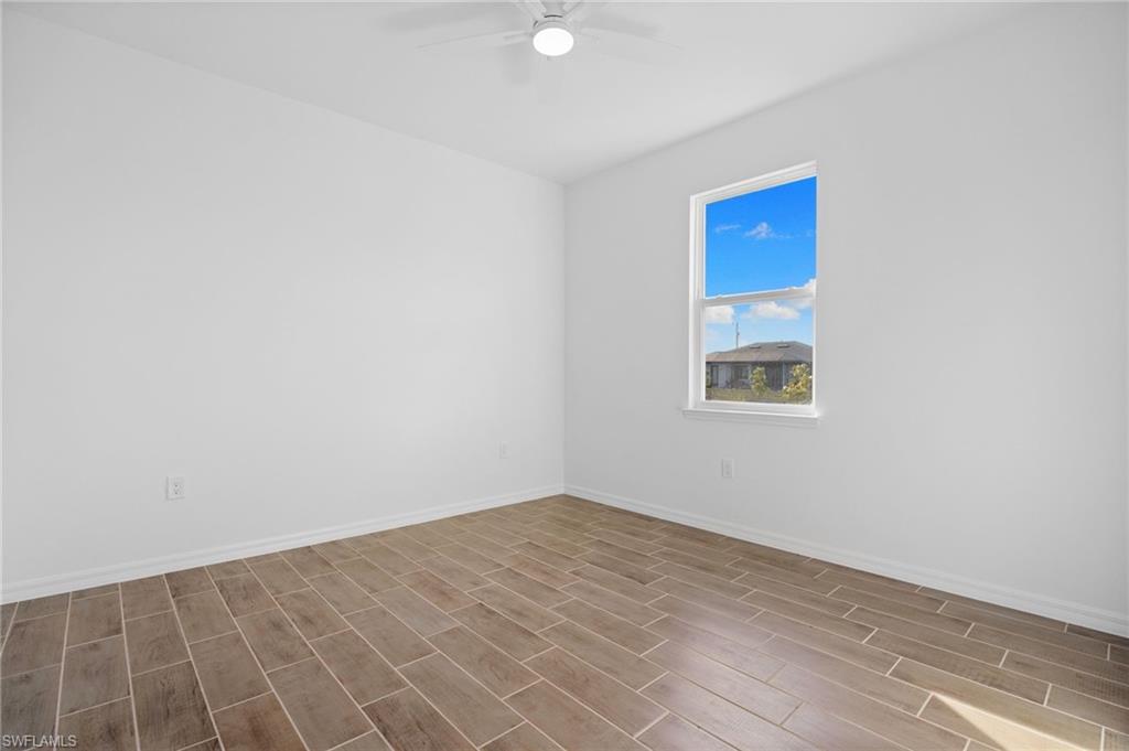 Spare room featuring wood finish floors and ceiling fan