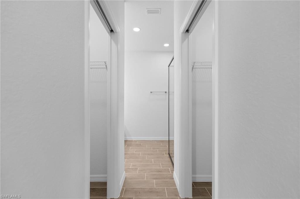 Hallway with recessed lighting and wood tiled floors