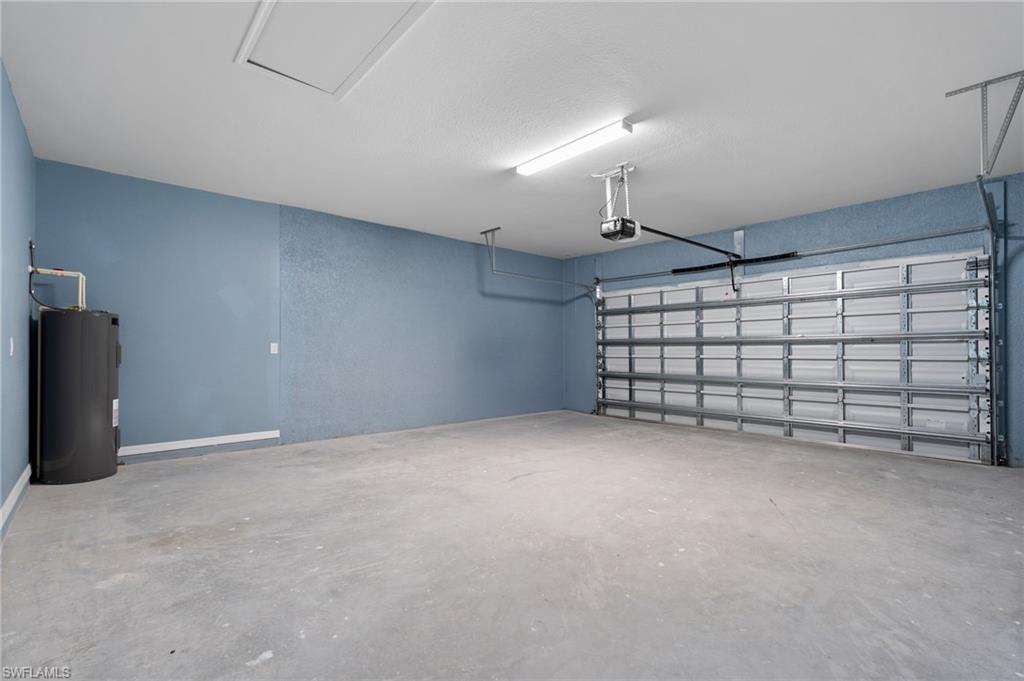 Garage with electric water heater and a garage door opener