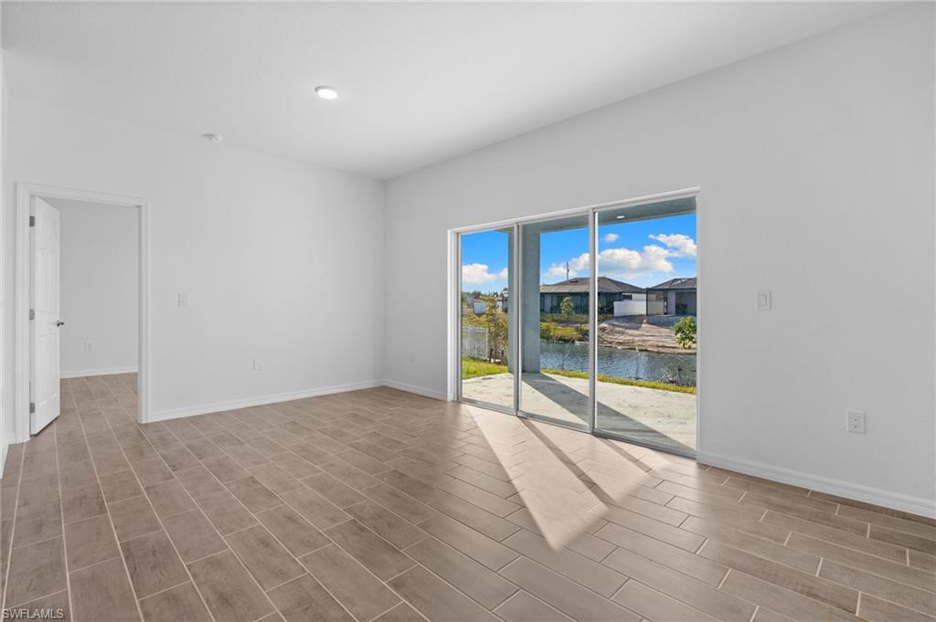 Spare room with wood tiled floors and a water view