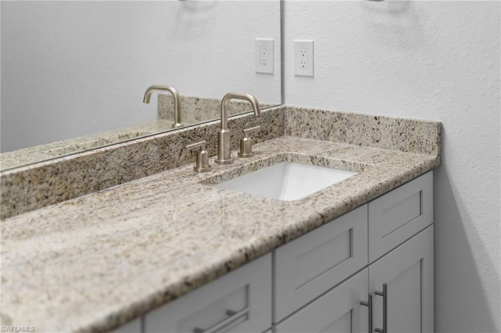 Bathroom featuring vanity and a textured wall