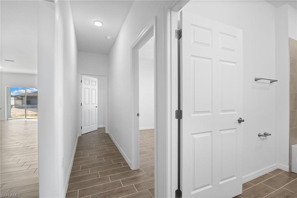 Hall with wood finish floors and baseboards