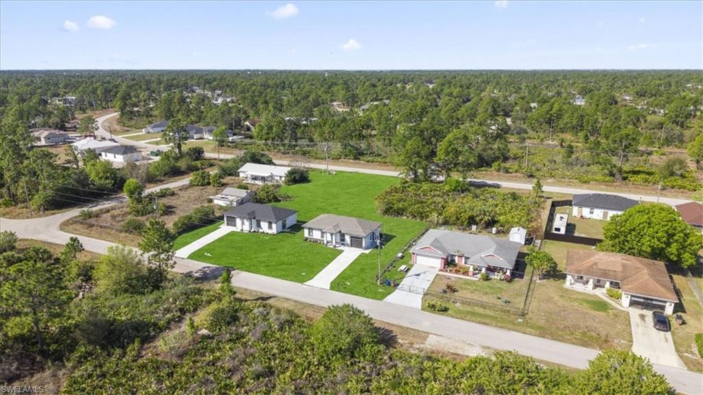 Aerial view of residential area featuring a heavily wooded area