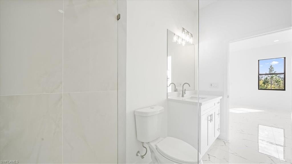 Bathroom featuring vanity and light marble finish flooring