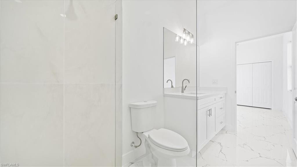 Full bathroom with vanity and light marble finish flooring