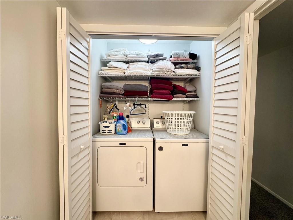 Laundry area featuring independent washer and dryer located in the Primary bathroom