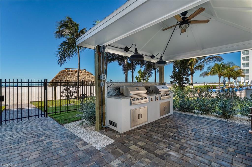 Patio with area for grilling and ceiling fan