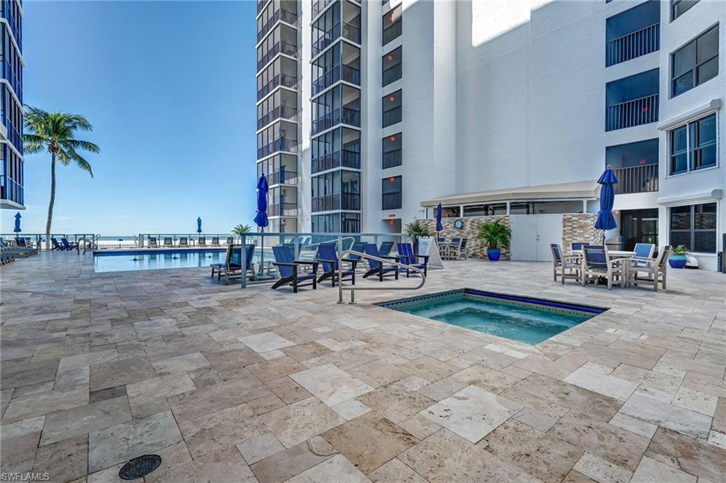Community pool featuring a hot tub, a patio, and outdoor dining area