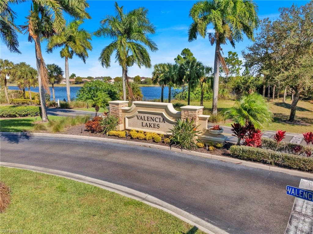 Community / neighborhood sign featuring a water view