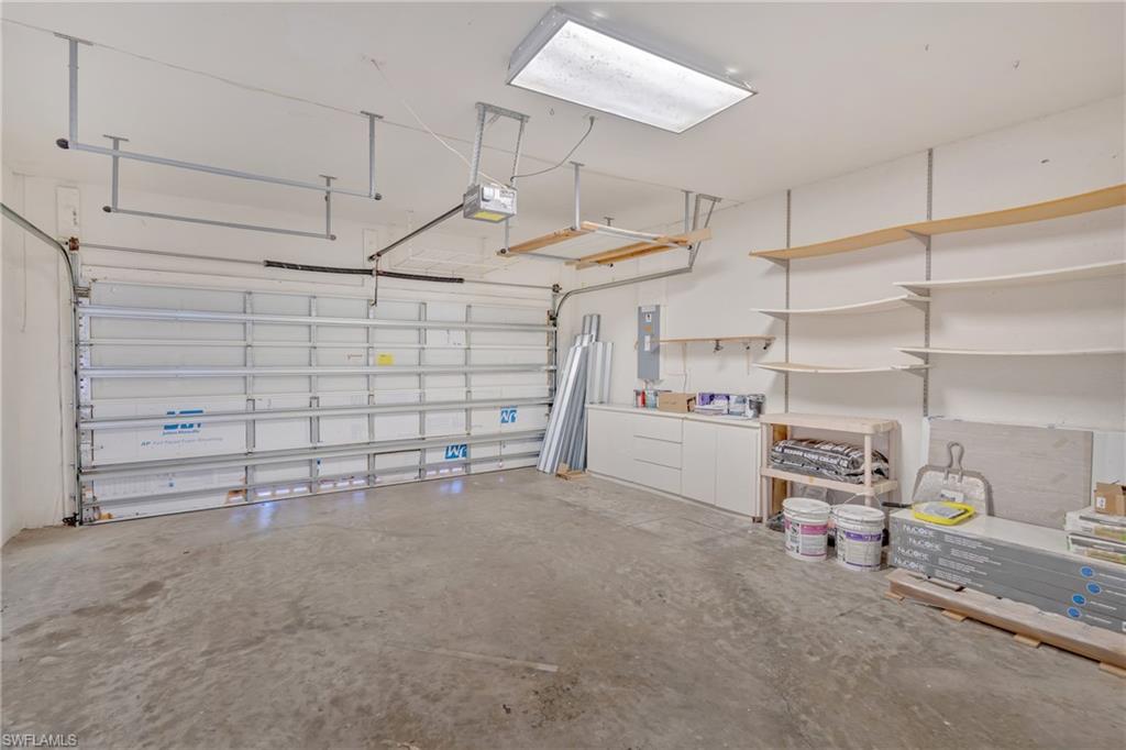 Garage with electric panel and a garage door opener