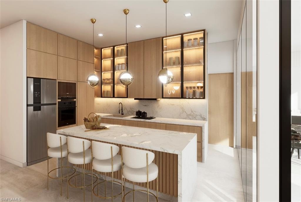 Kitchen featuring light wood finish cabinetry, freestanding refrigerator, modern cabinets, light stone counters, and oven (Rendered photo)