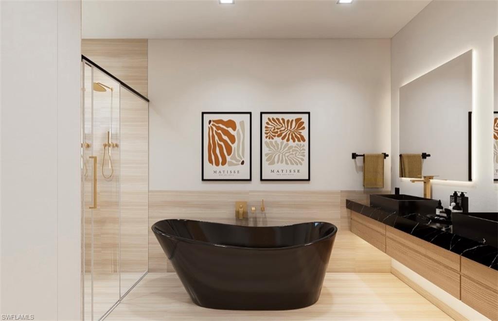 Bathroom featuring a shower stall, vanity, a freestanding tub, and tile walls (Rendered photo)