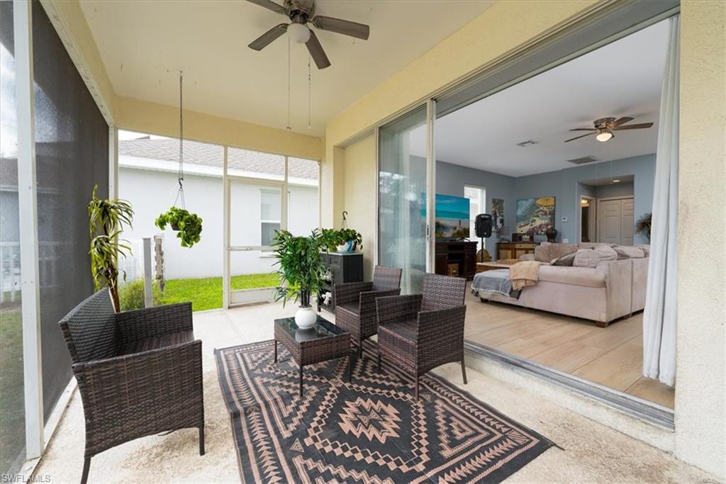 Screened-in Lanai off Living Room with view of backyard & lake