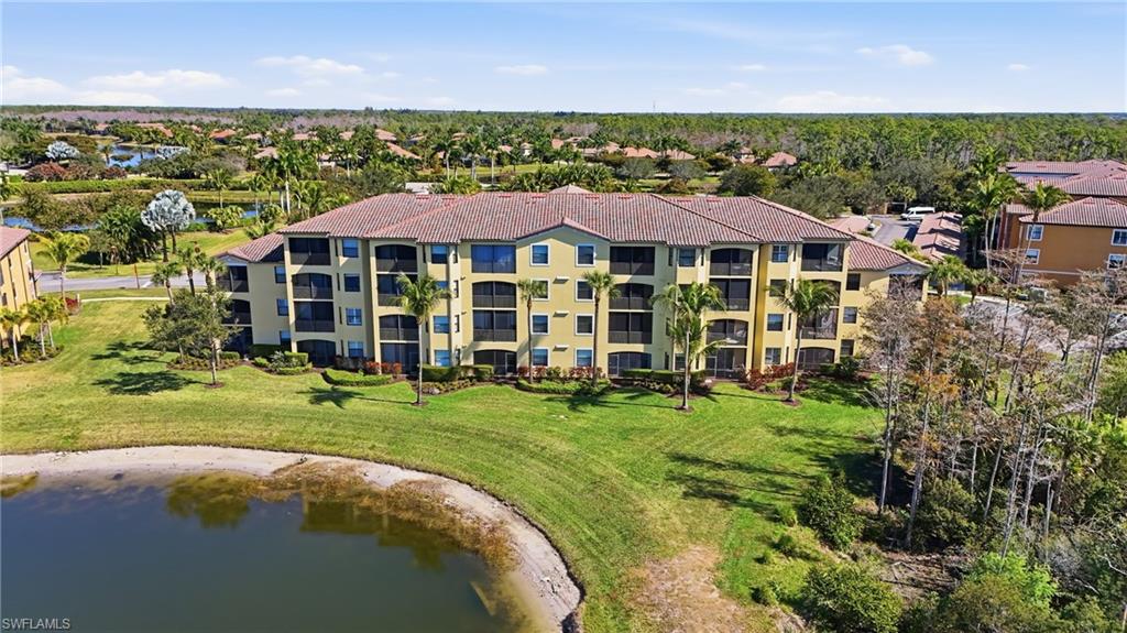 Drone / aerial view of a large body of water and apartment complex / building