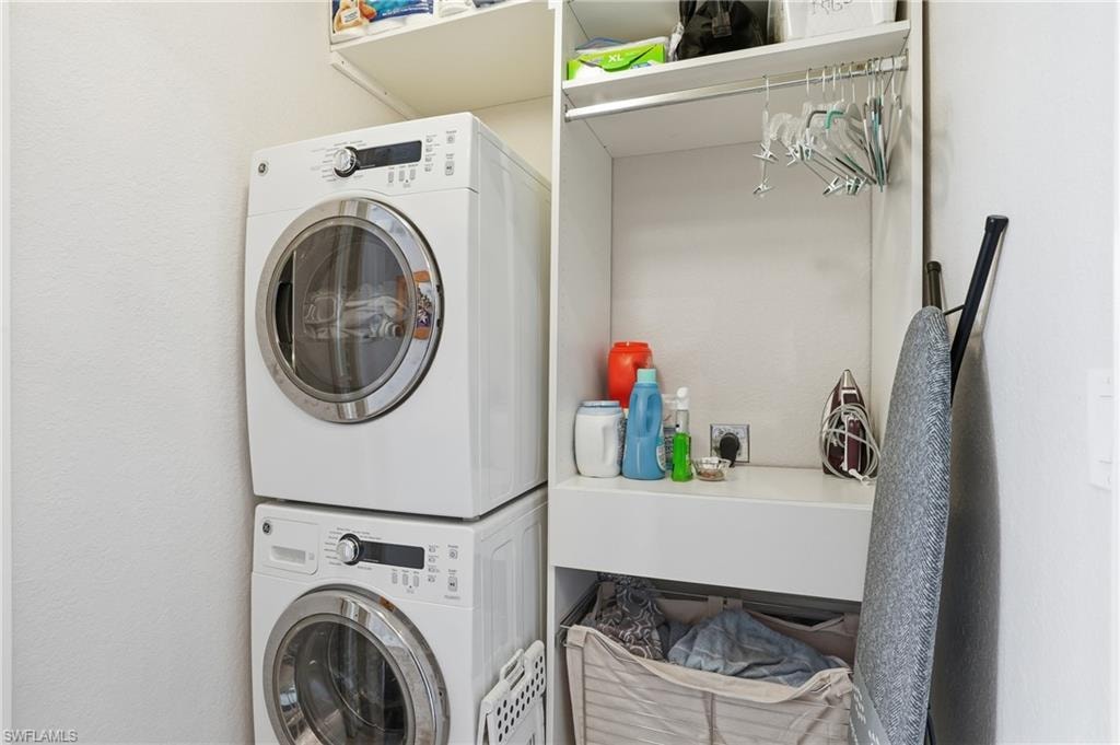 Laundry room featuring stacked washer / drying machine