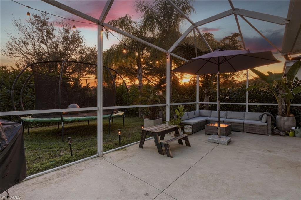 View of patio / terrace with a trampoline, a lanai, a sunroom, and an outdoor hangout area