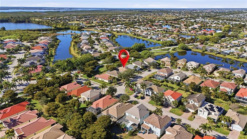 Aerial overview of property's location featuring nearby suburban area and a nearby body of water