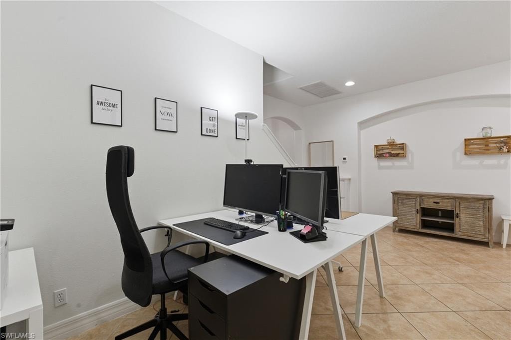 Home office featuring light tile patterned floors and recessed lighting