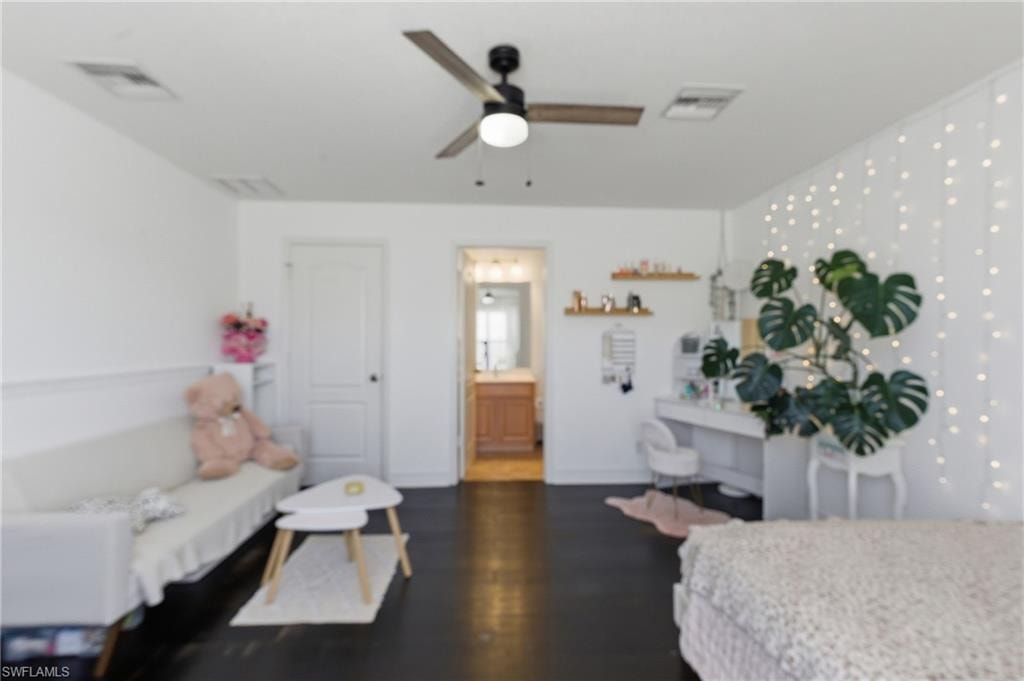 Bedroom with dark wood-style flooring and ceiling fan
