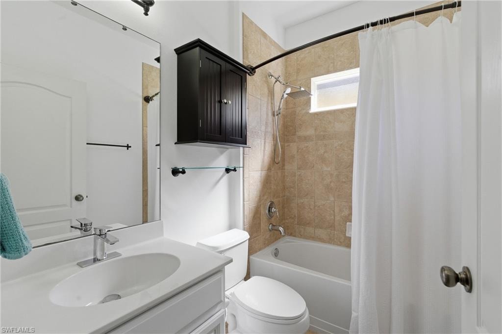 Full bathroom featuring shower / tub combo and vanity