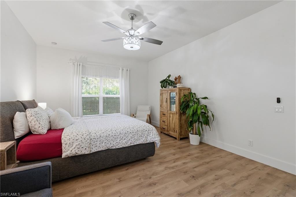 Bedroom featuring wood finished floors and a ceiling fan