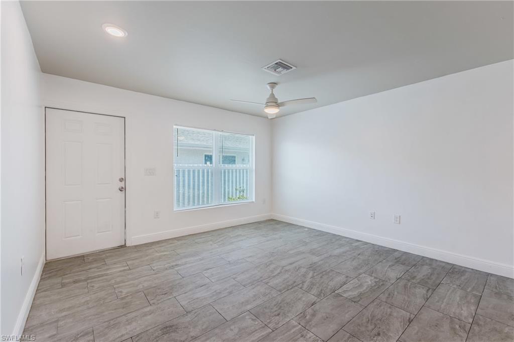 Spare room with baseboards and a ceiling fan