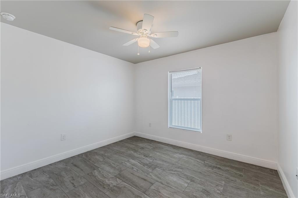 Spare room with ceiling fan and a smoke detector