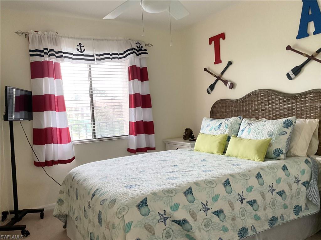 Guest Bedroom with ceiling fan and carpet