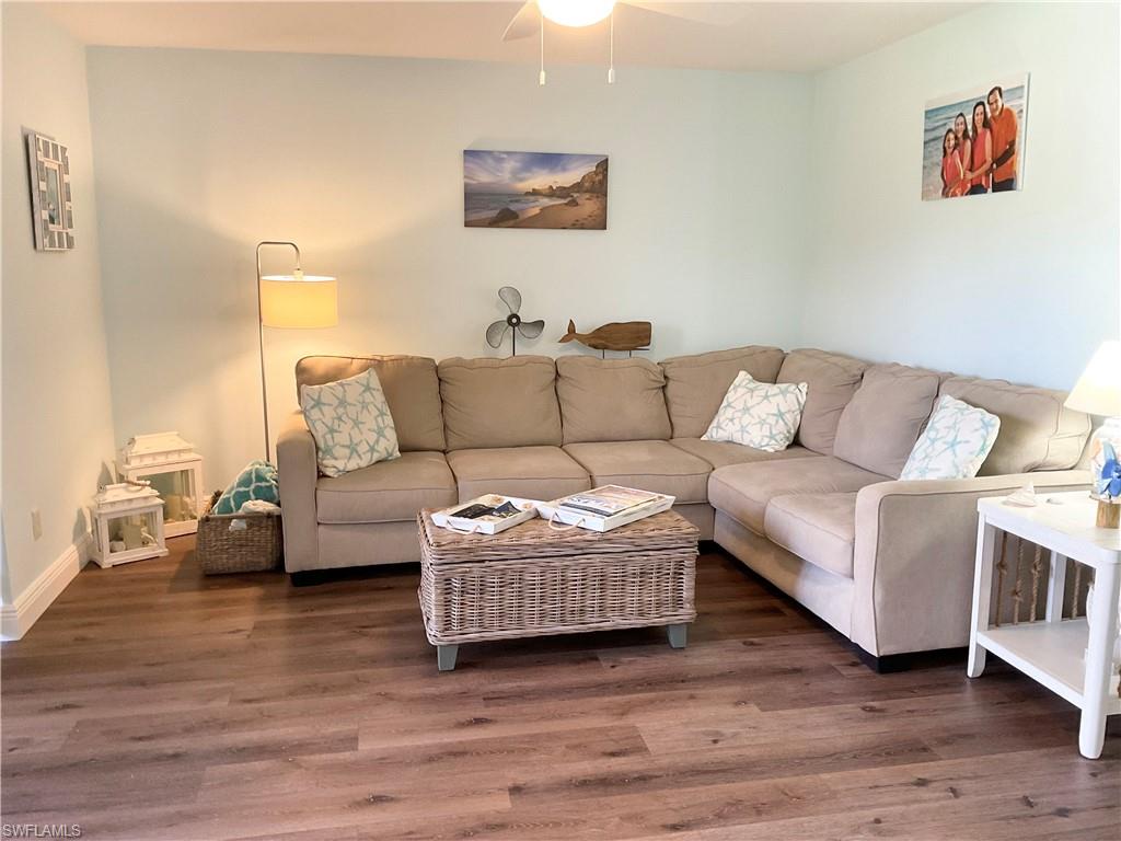 Living area with vinyl planked flooring and TV