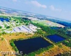 Aerial view of property and surrounding area featuring a nearby body of water