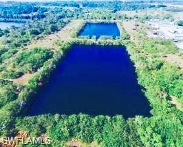 Aerial view of property and surrounding area featuring a large body of water