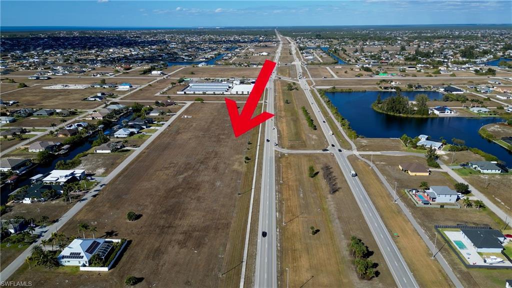 View of property location with nearby suburban area and a large body of water