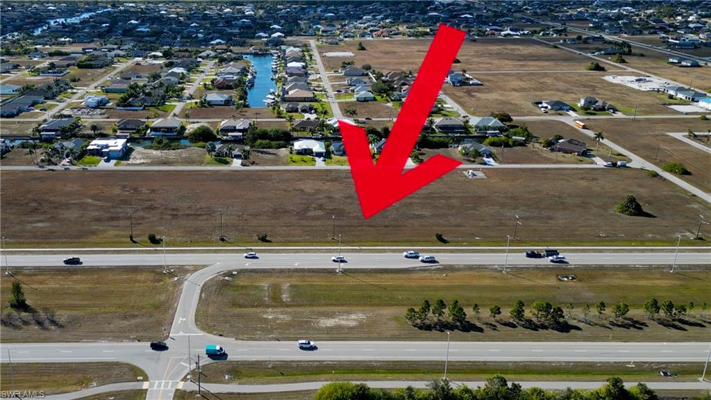 Aerial view of property and surrounding area with nearby suburban area
