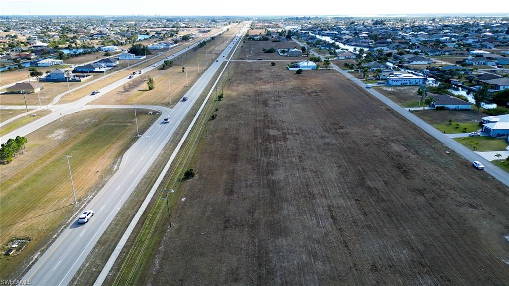Aerial overview of property's location featuring nearby suburban area