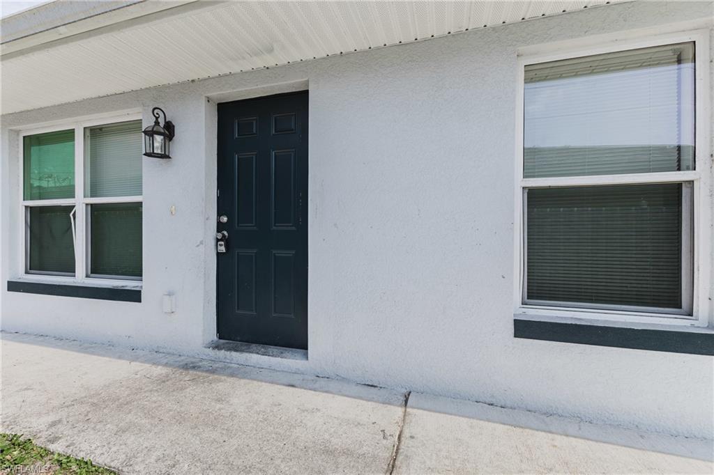 Entrance to property with stucco siding