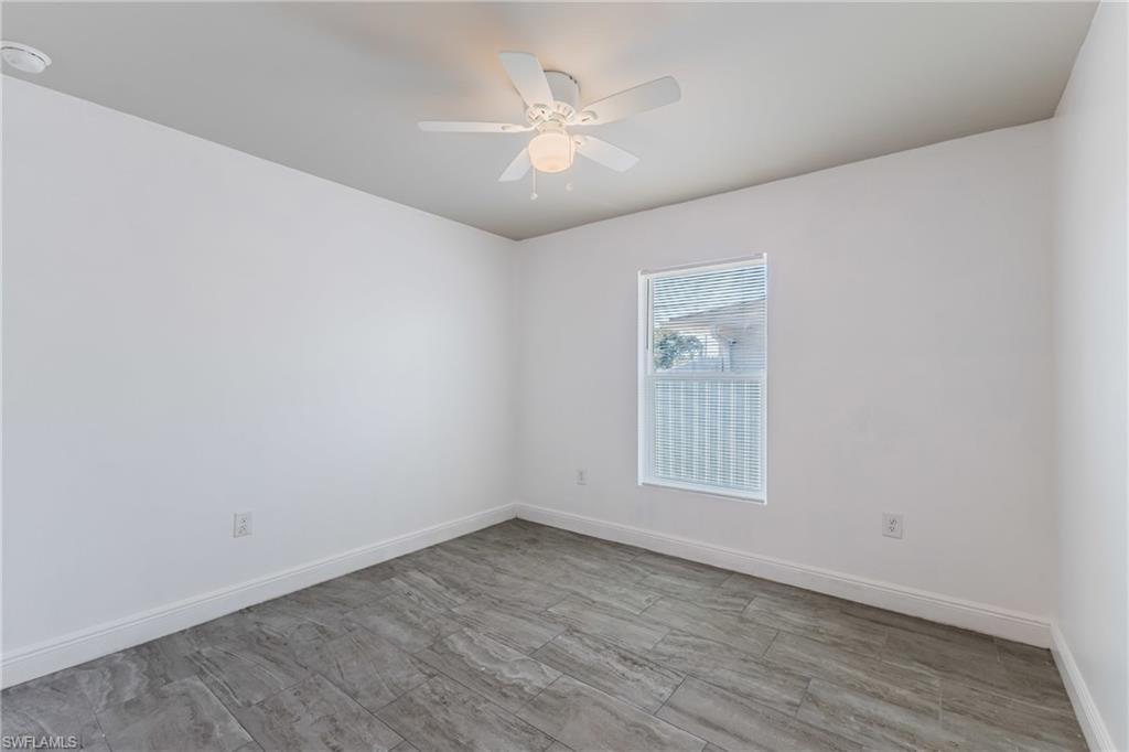 Unfurnished room featuring ceiling fan and wood finish floors
