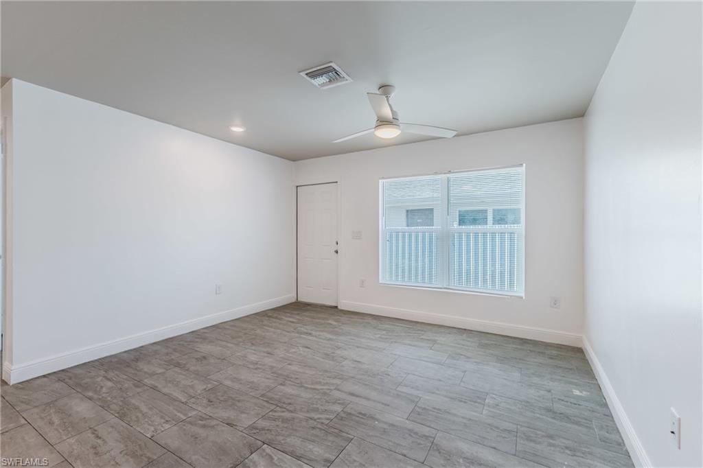Empty room featuring a ceiling fan and recessed lighting