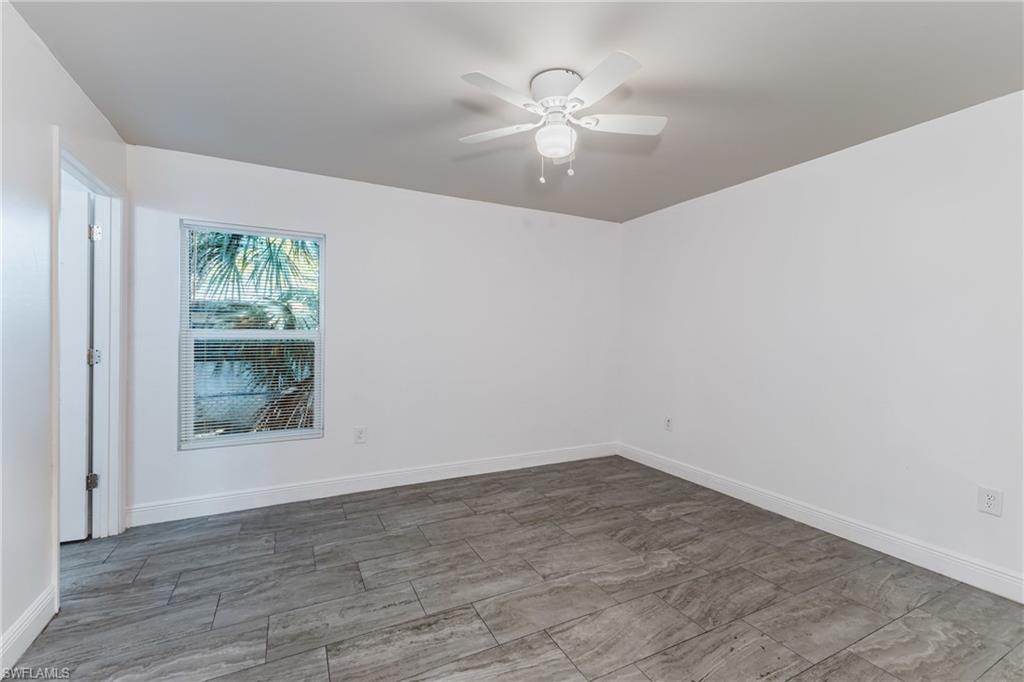 Unfurnished room featuring a ceiling fan and wood finish floors