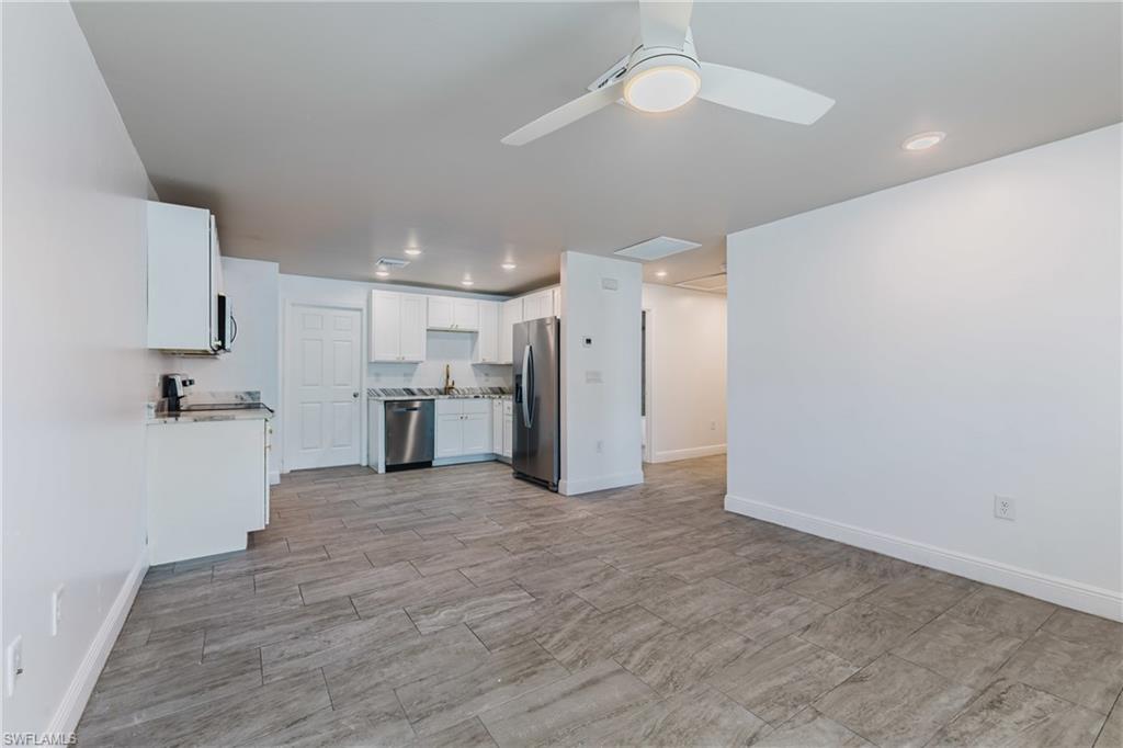 Kitchen featuring white cabinetry, stainless steel appliances, ceiling fan, and recessed lighting