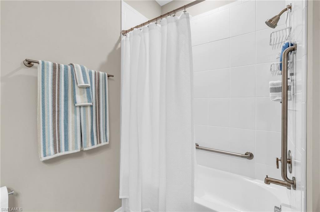 Bathroom featuring shower / bath combination with curtain