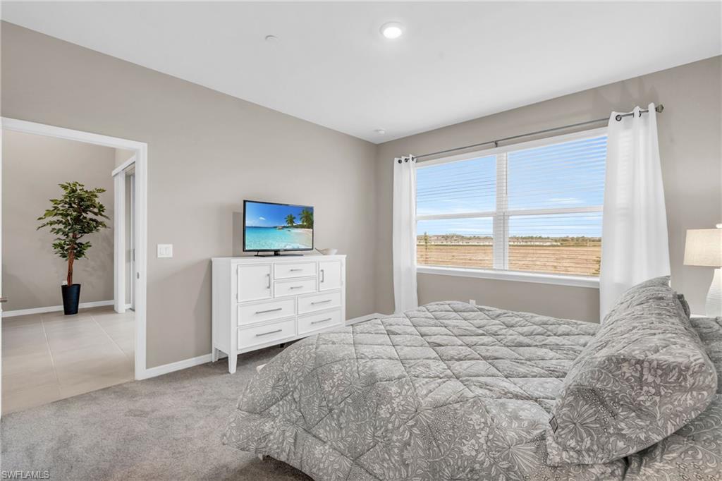 Bedroom featuring light colored carpet