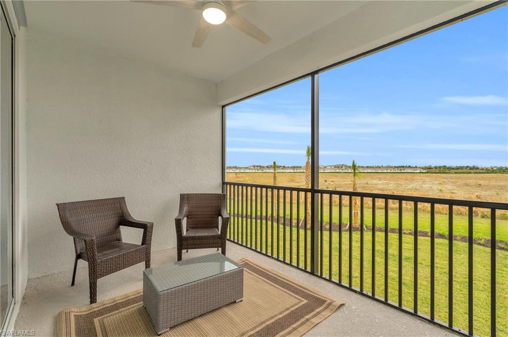 Balcony featuring ceiling fan and a rural view