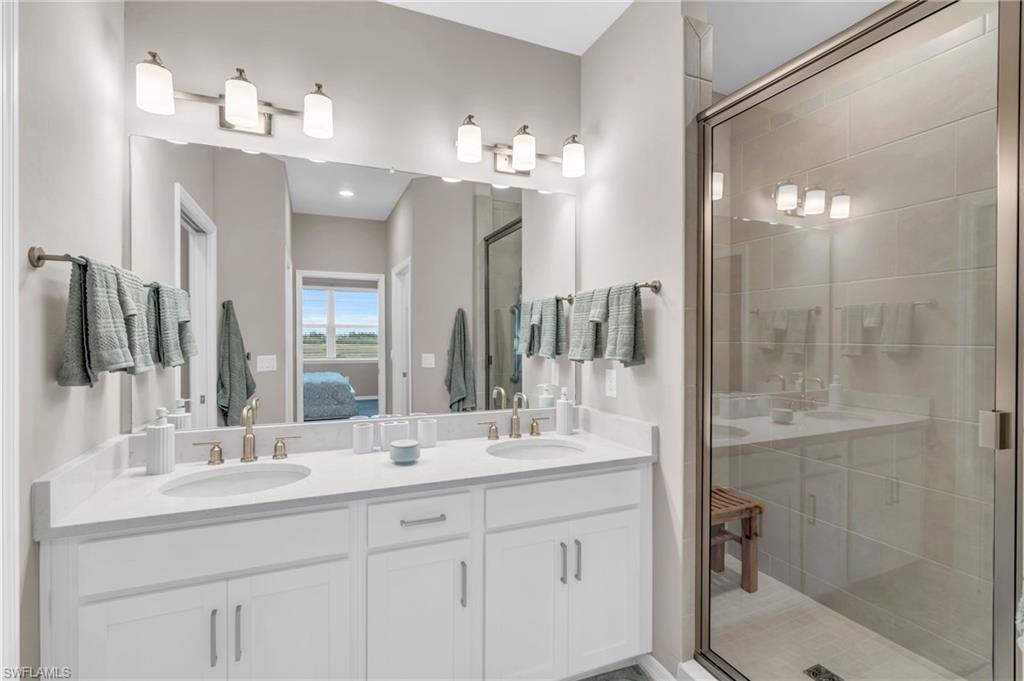 Bathroom featuring an enclosed shower and vanity