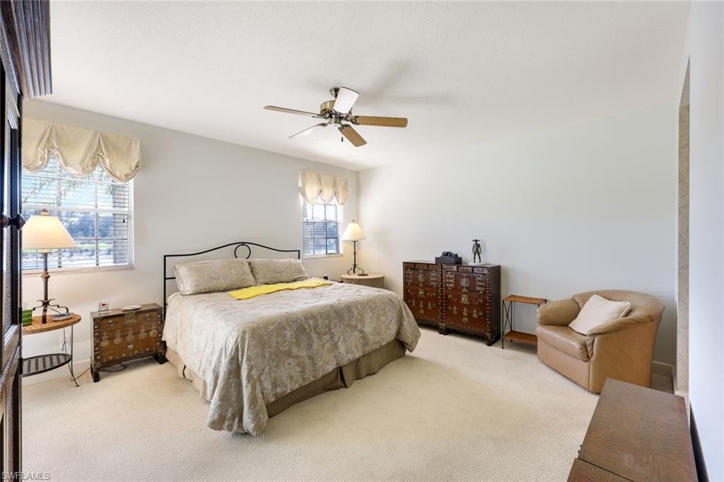 Carpeted bedroom with ceiling fan