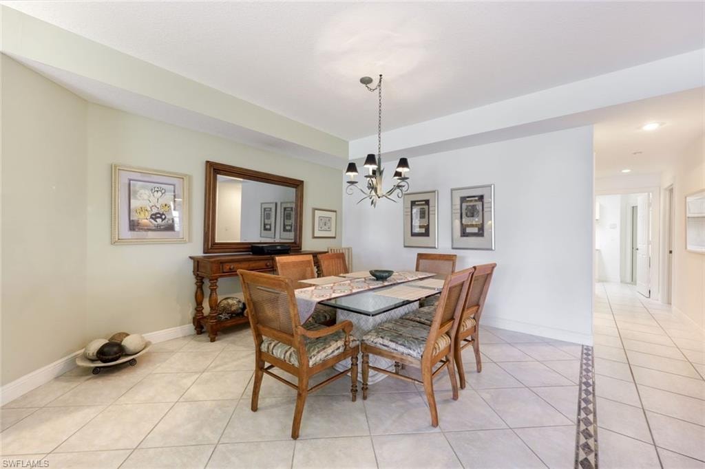 Dining room featuring light tile patterned flooring and suspended lighting